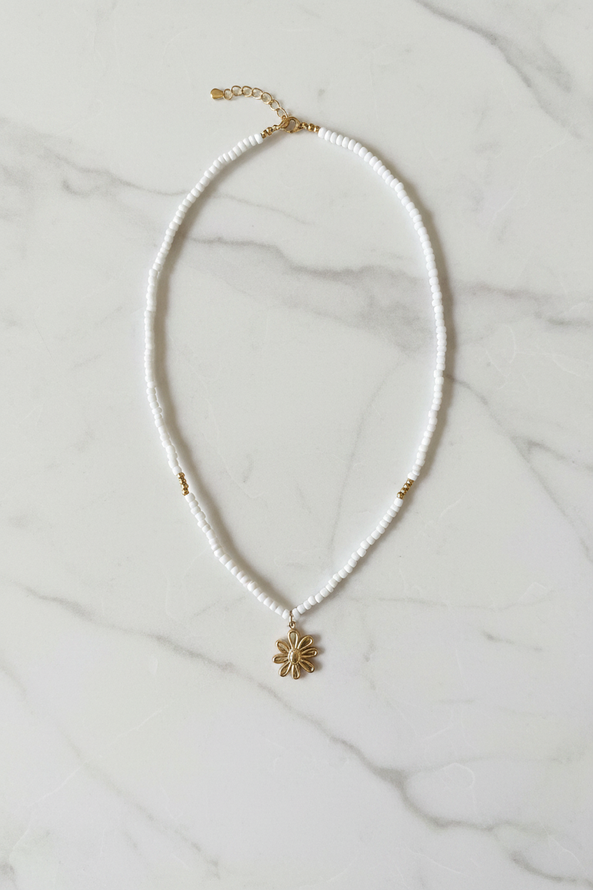 Beaded Floral Necklace on marble background