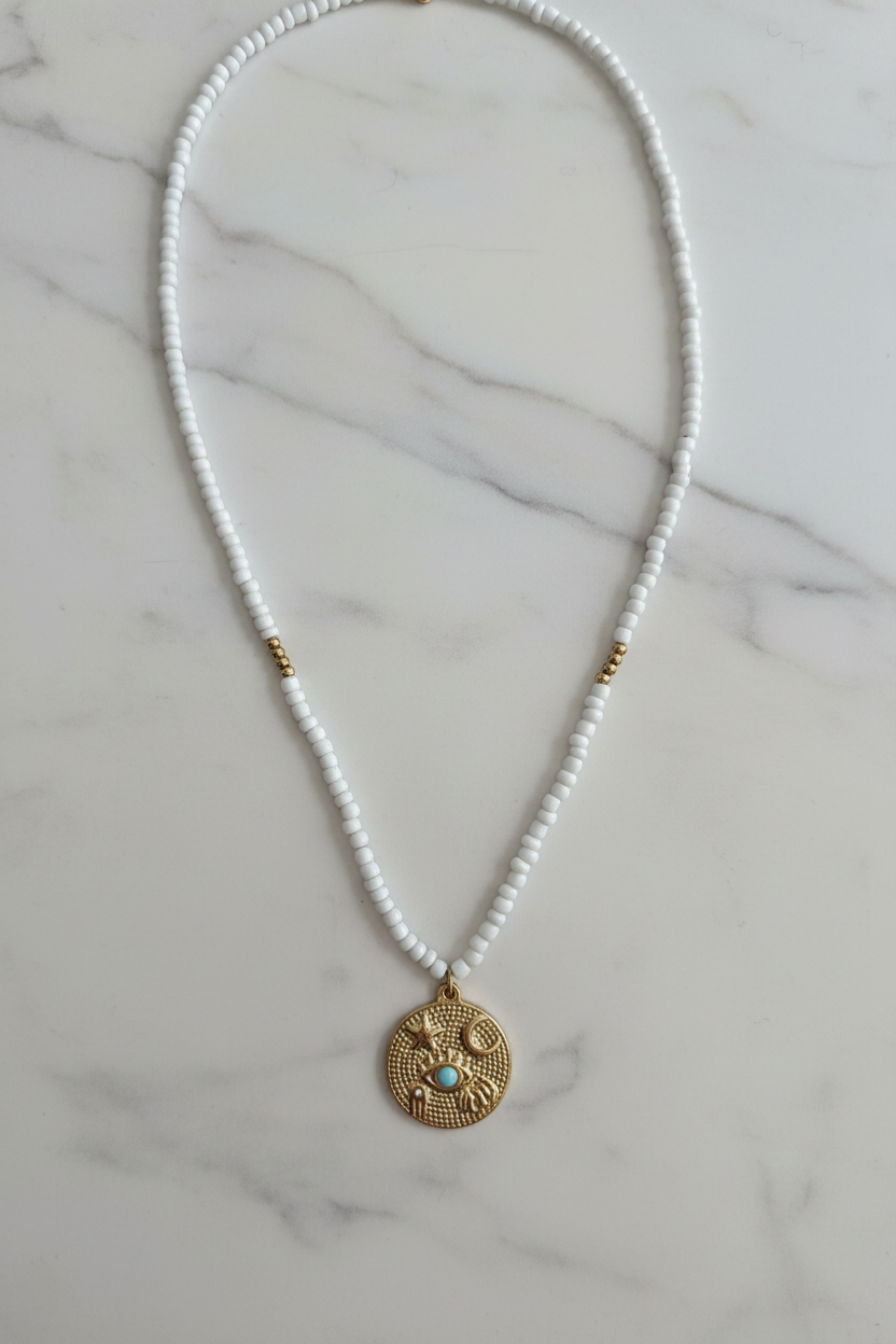 Beaded Coin Necklace on marble background