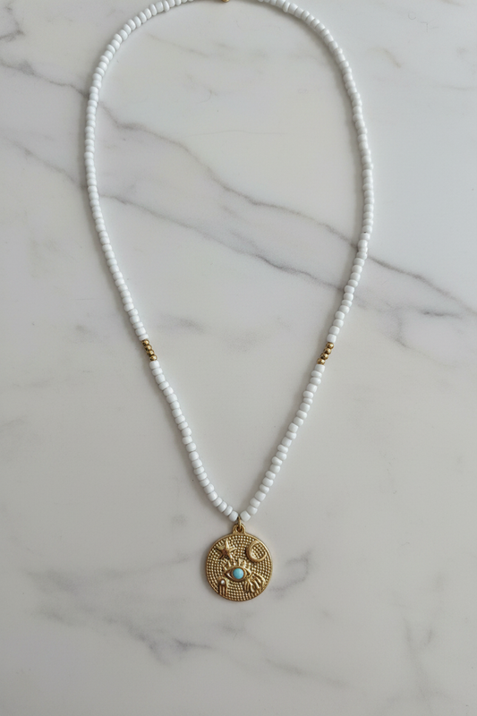 Beaded Coin Necklace on marble background