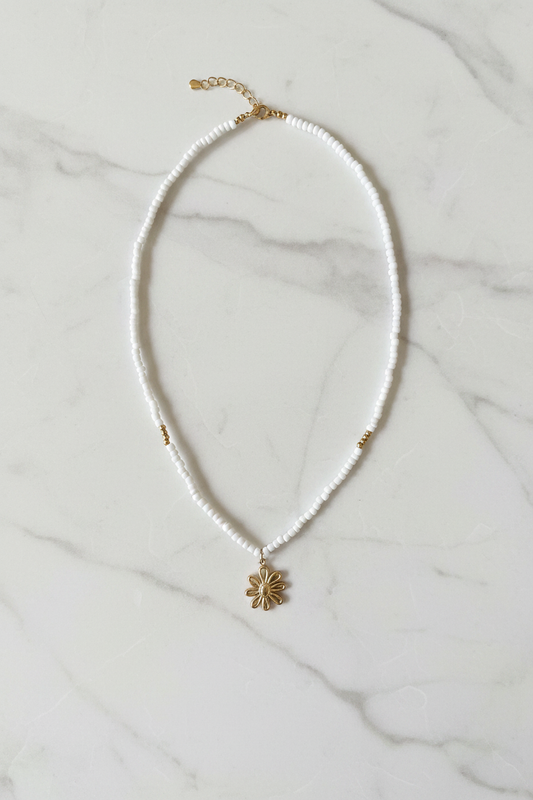 Beaded Floral Necklace on marble background