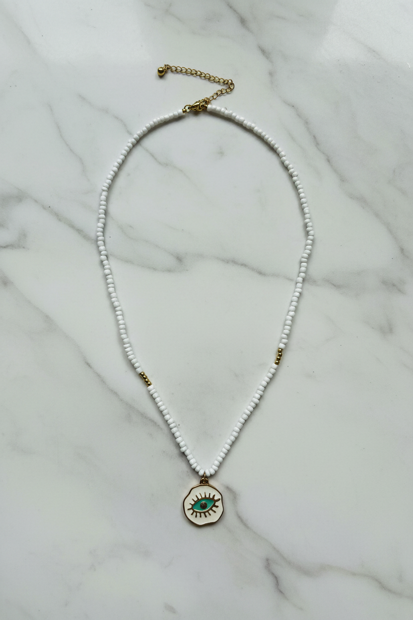 Beaded Evil Eye Necklace on marble background